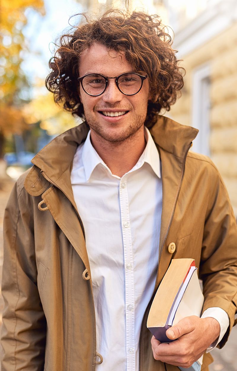 Young man wearing designer eyeglasses from Destination Eye Care